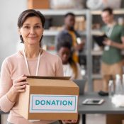 staff member holding a donations box
