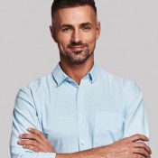 staff member smiling with arms crossed