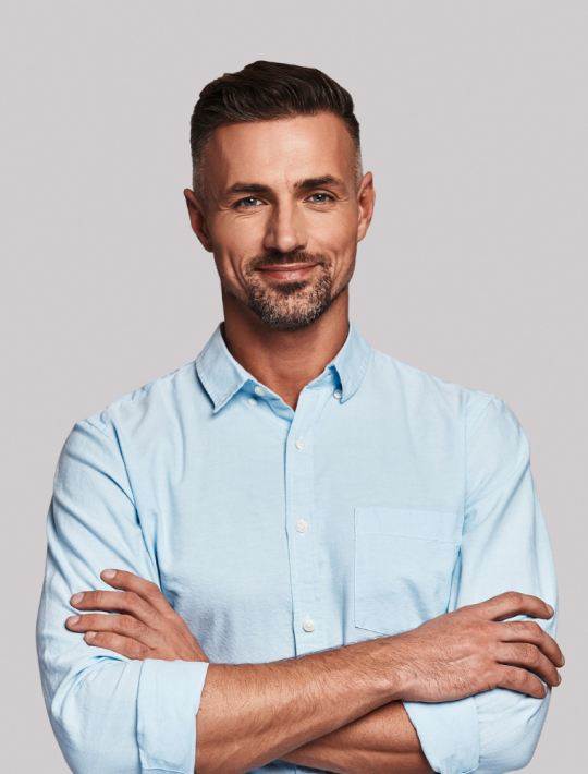 staff member smiling with arms crossed